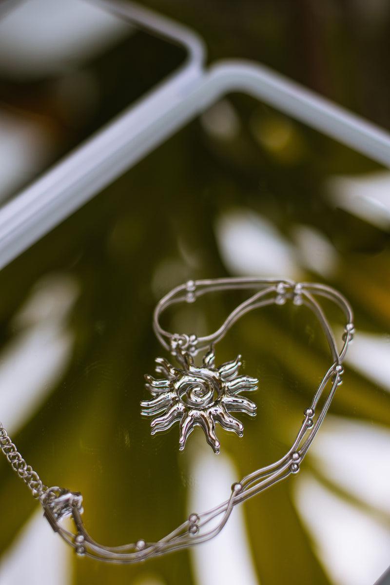 The Say It Softly Charm, silver sun charm